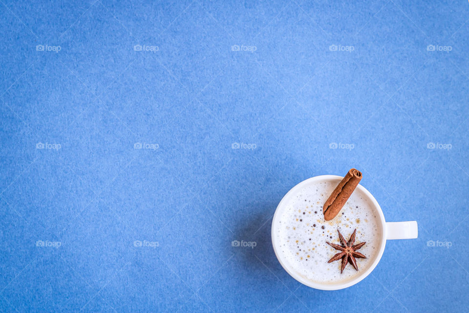 Top view to cup with coffee with anise and cinnamon.