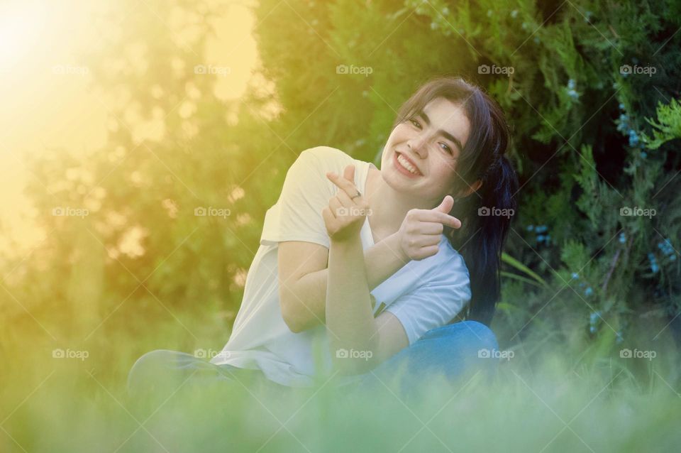 Beautiful Smiley Face of Girl sitting on the grass 