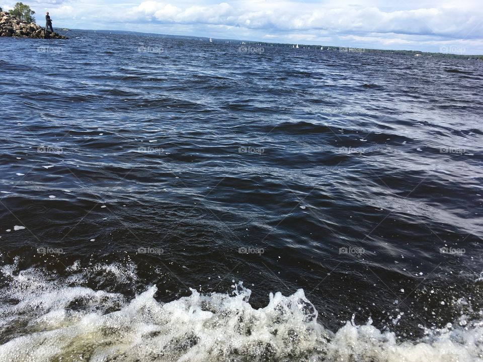 Waves from speedboat on river