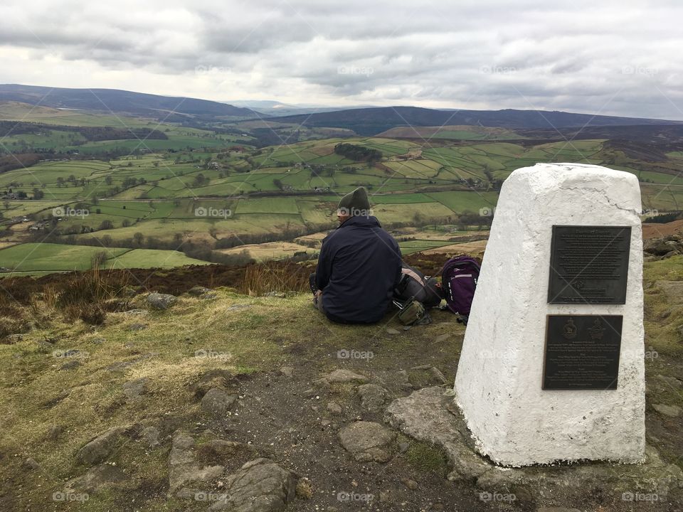 Man sat on top of hill by Beamsley Top trig point Yorkshire 