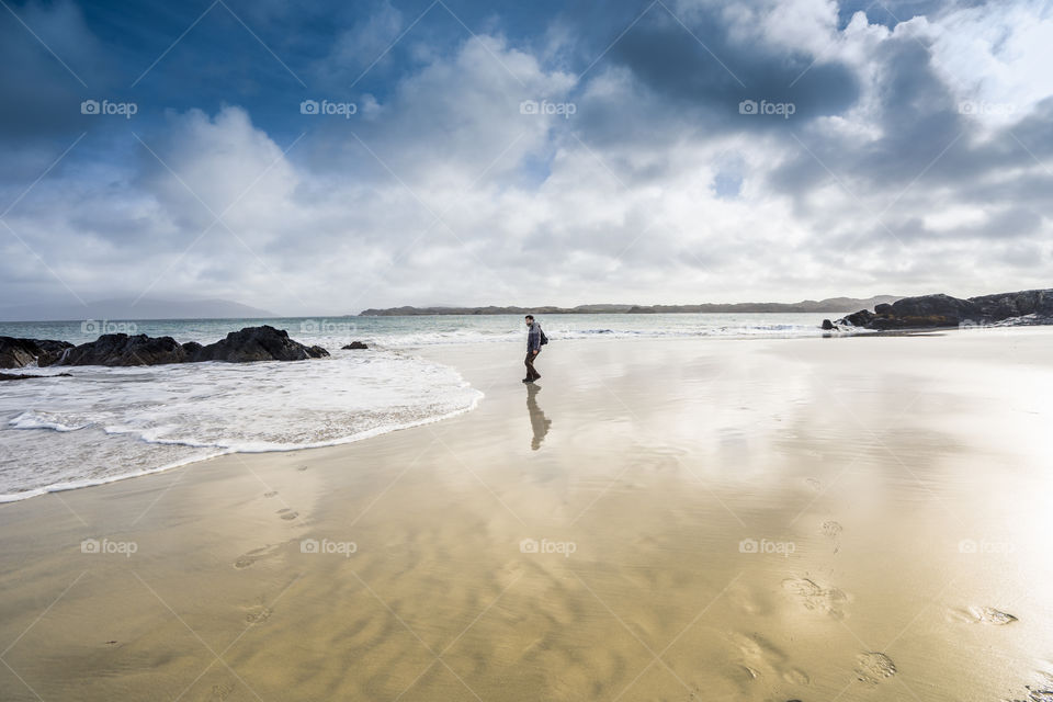 tiny man on a big world, shore landscape in the winter