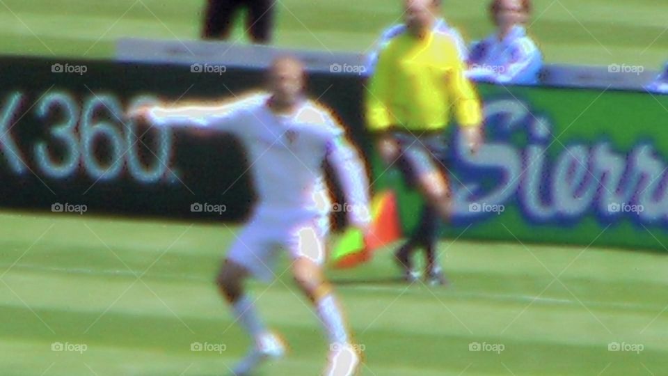 Professional soccer game with player in motion on the field 