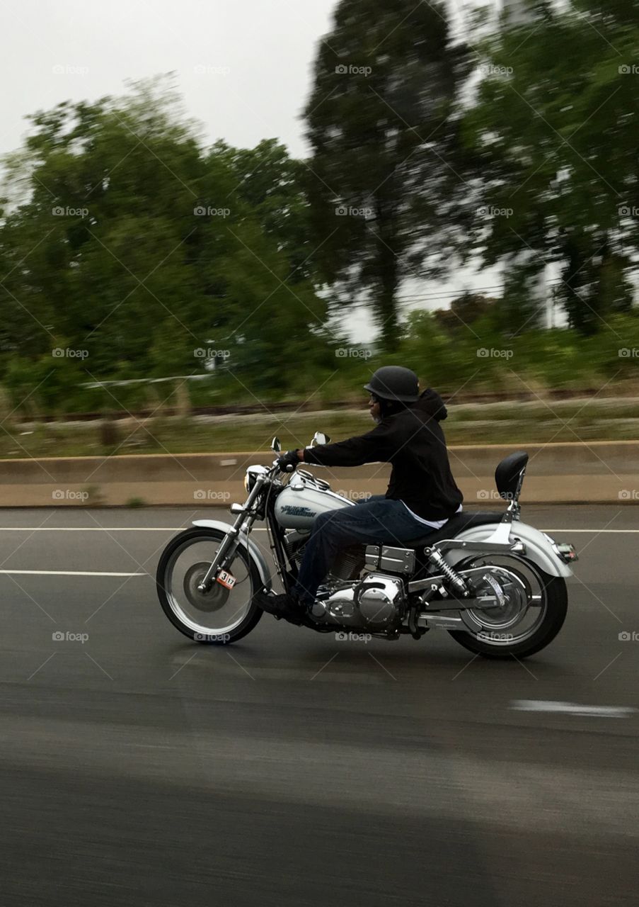 Lone Rider on Highway riding Silver Harley