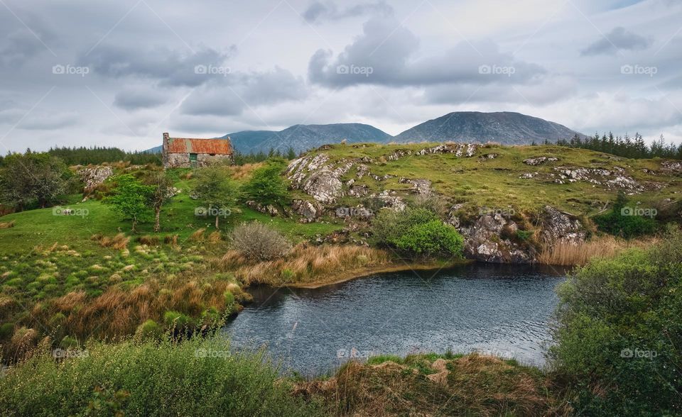 Old cottage on green hill at Connemara National park in county Galway, Ireland