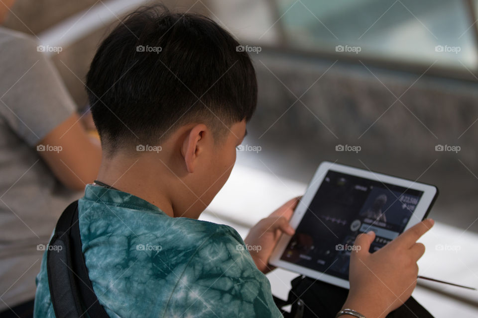 Boy playing iPad 