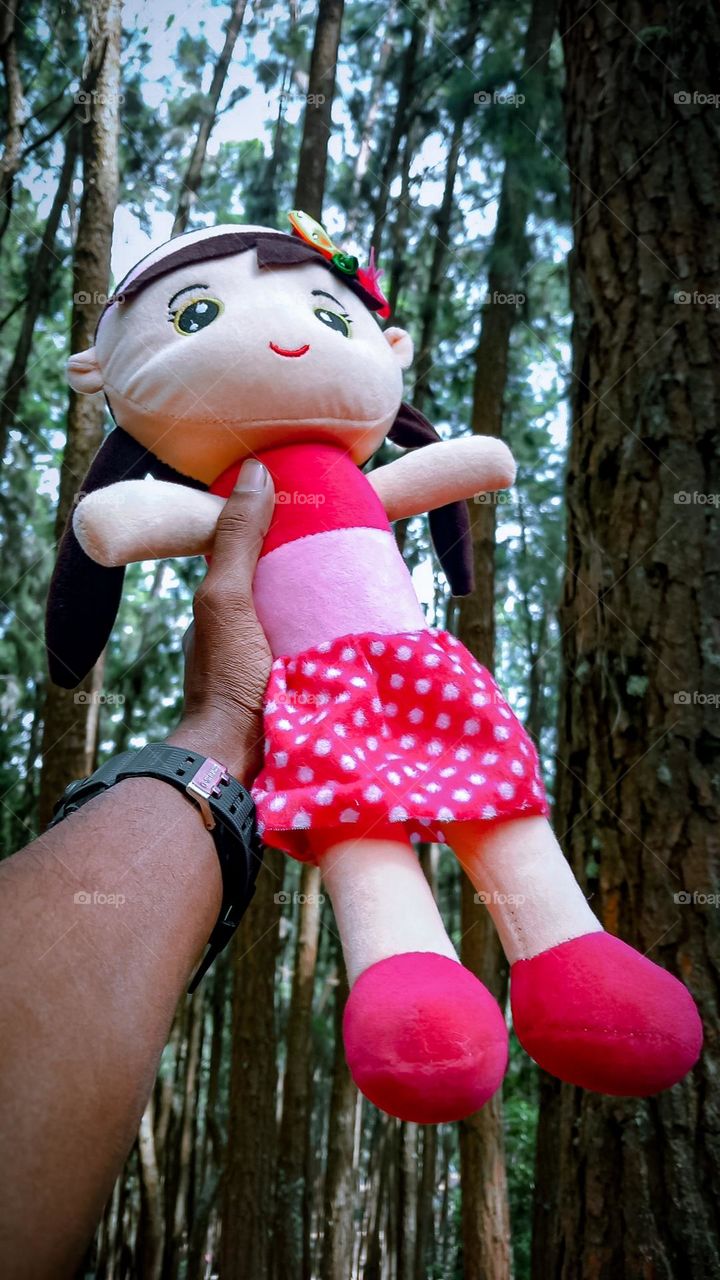 cute pink doll in my hand