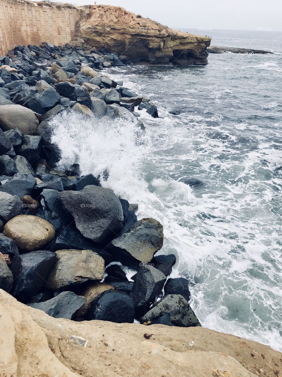 Waves crashing against the rocks on a beach