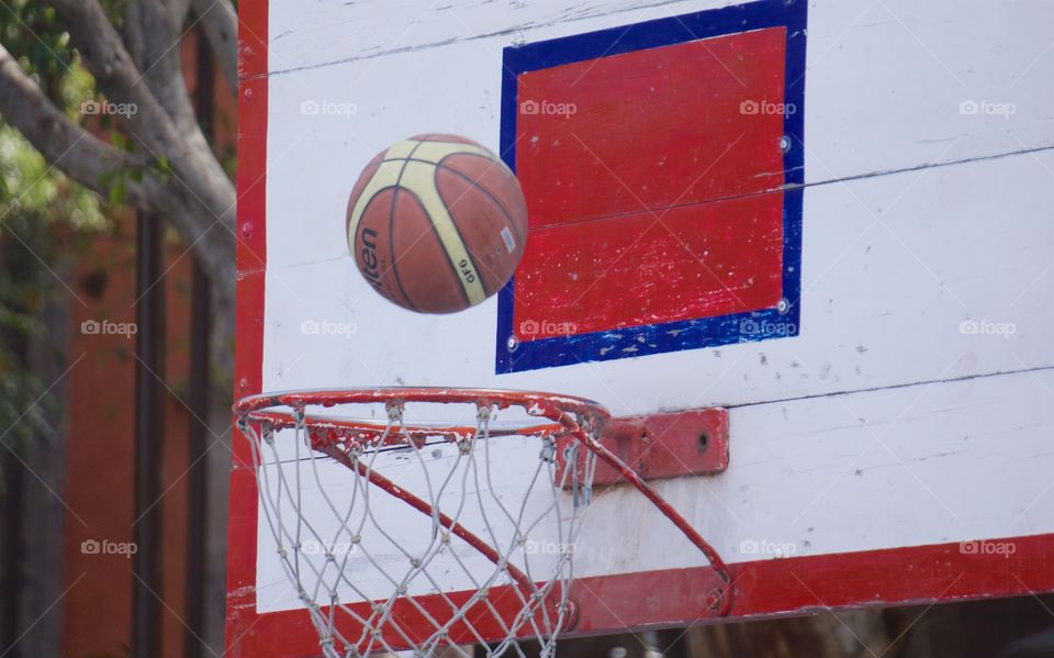 During a basketball game in San Miguel
 de Allende, Mexico, the ball is about to go through the hoop for a basket,

