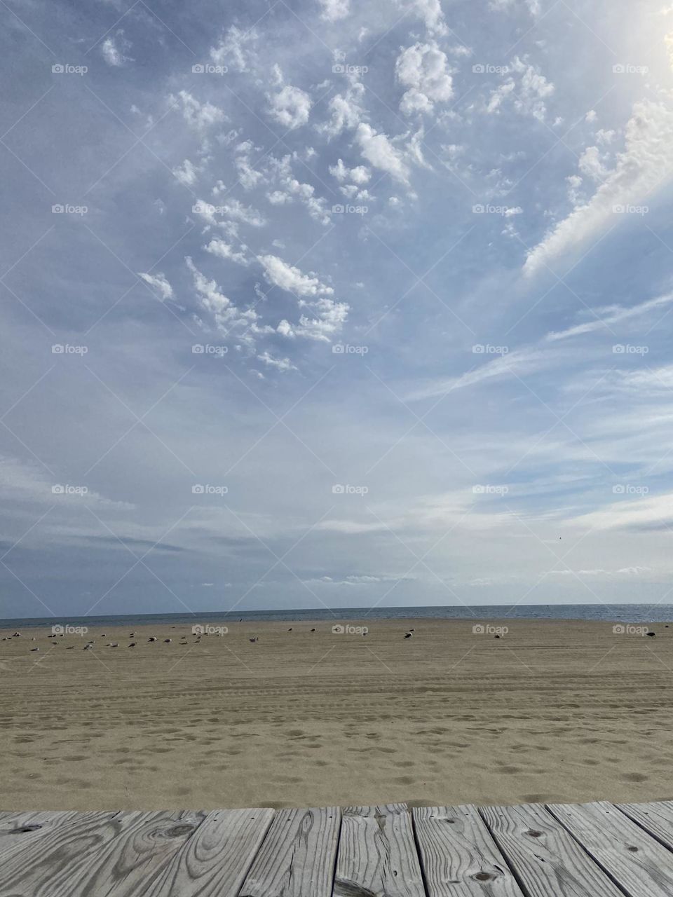 The beach in September, otherwise known as “local summer.” The crowds are gone, and all that can be seen on the beach on this Sunday morning is some seagulls. I love the pattern of the clouds in this picture. The seagulls have the right idea.