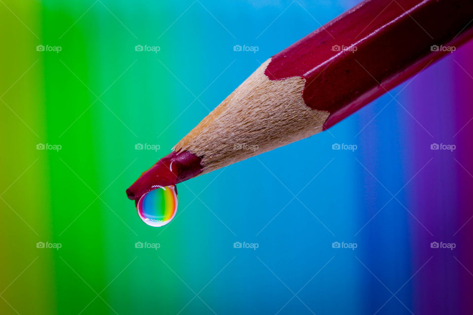 Water drop on a red pencil