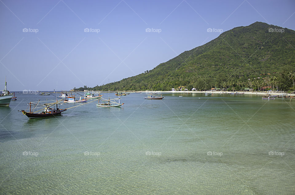 Fishing boats parked on the Beach at Koh Phangan, Surat Thani in Thailand.