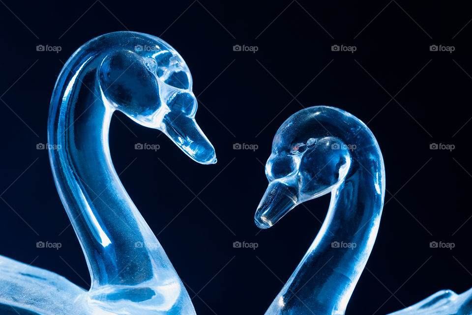 Couple of swans or geese made from glass. The blue makes the whole thing look like ice.