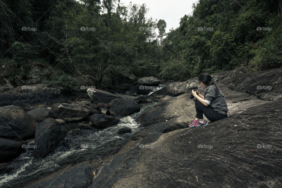 Girl looking at camera  at waterfall 