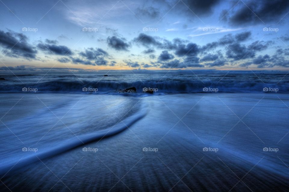 Idyllic view of sea against dramatic sky