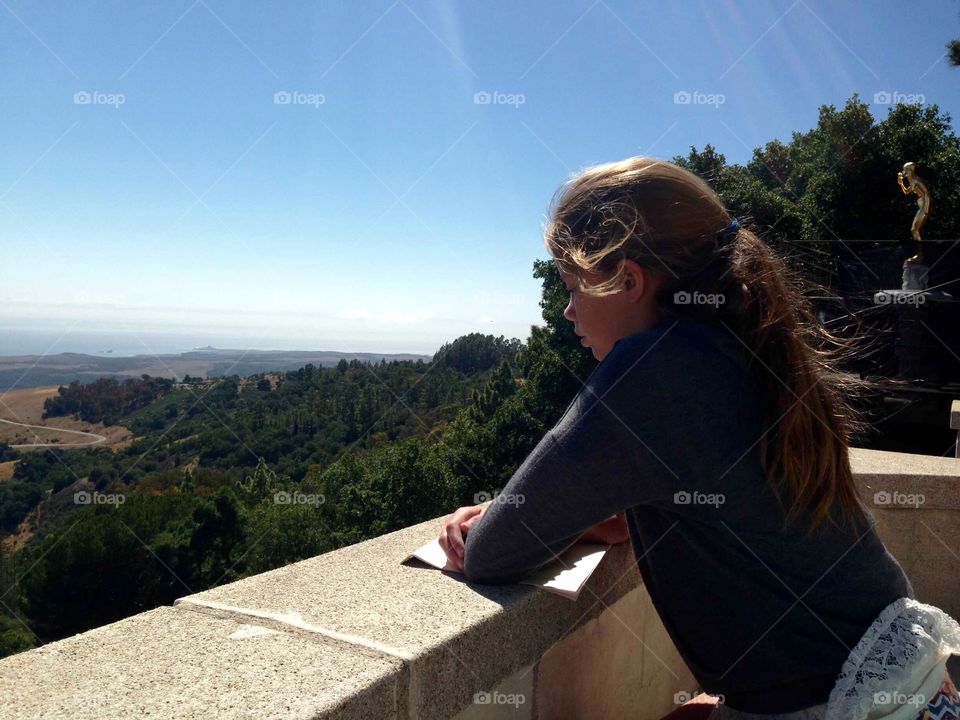 Girl Looking at Countryside. Girl in profile looking at the countryside and coastline visible from Hearst Castle.