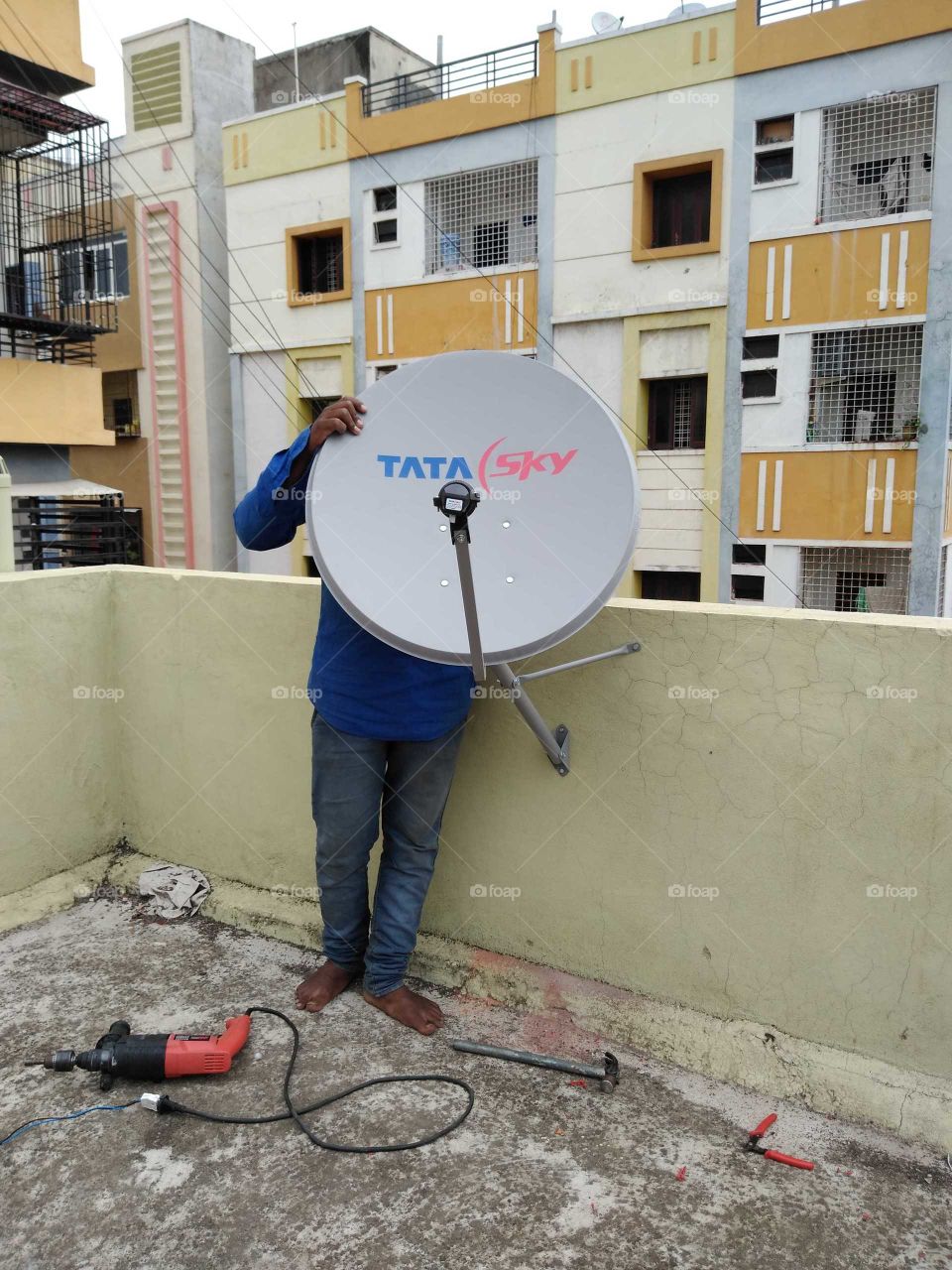 a guy installing dish TV