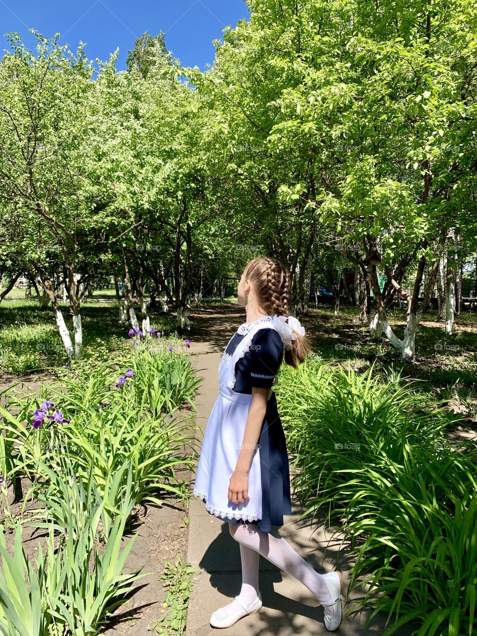 schoolgirl in school garden. Tomorrow the summer holidays begin!