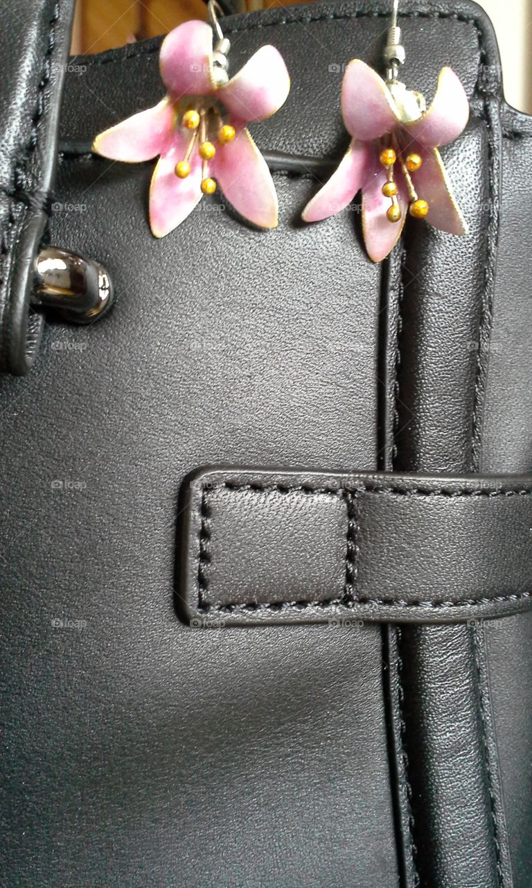 leather purse with pink flower earrings