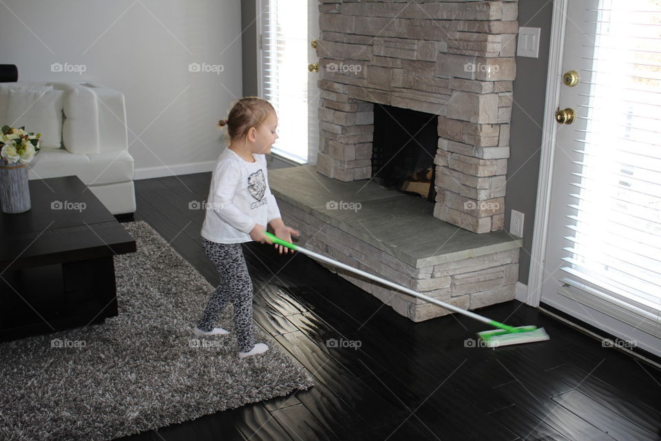 Child mopping floors