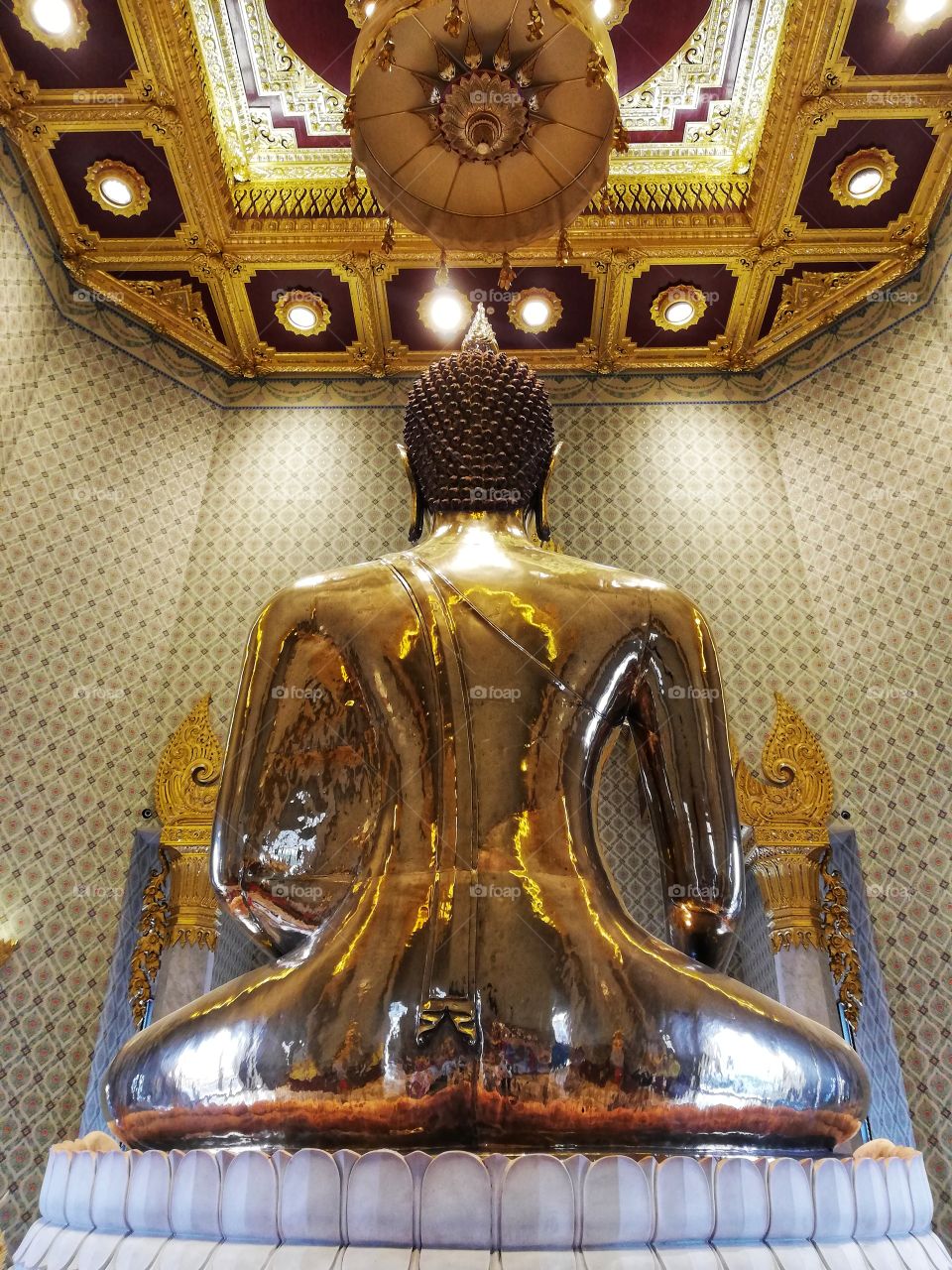 Golden buddha statue from behind in a Thai temple