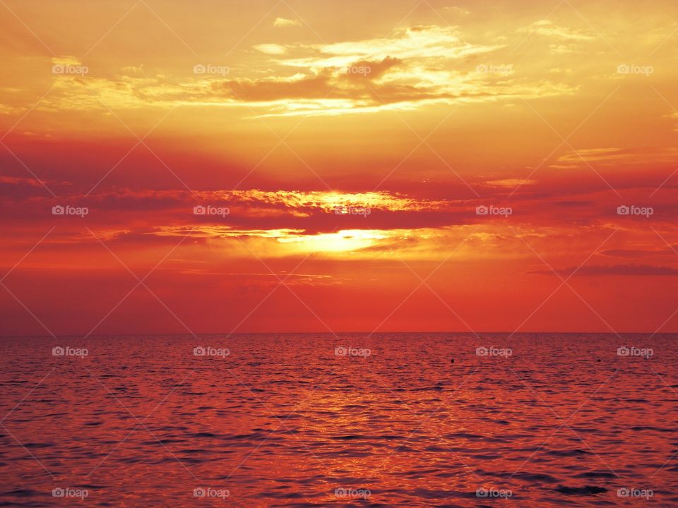 Idyllic view of sea against dramatic sky