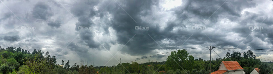 A panoramic shot of a dark and cloudy sky during a storm in central Portugal - April 2021