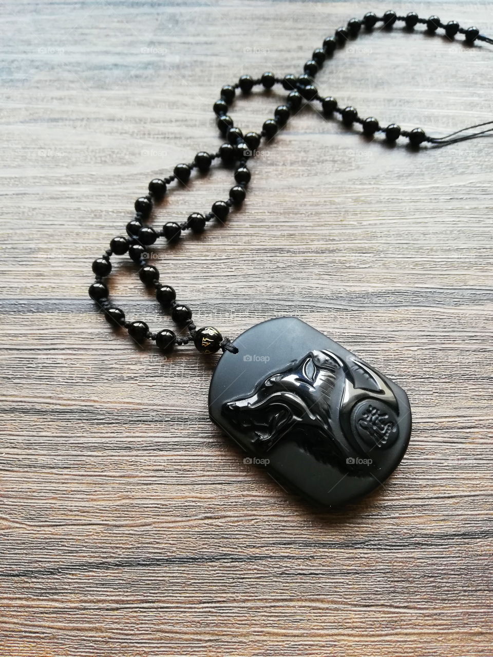 A necklace that have a wolf on it