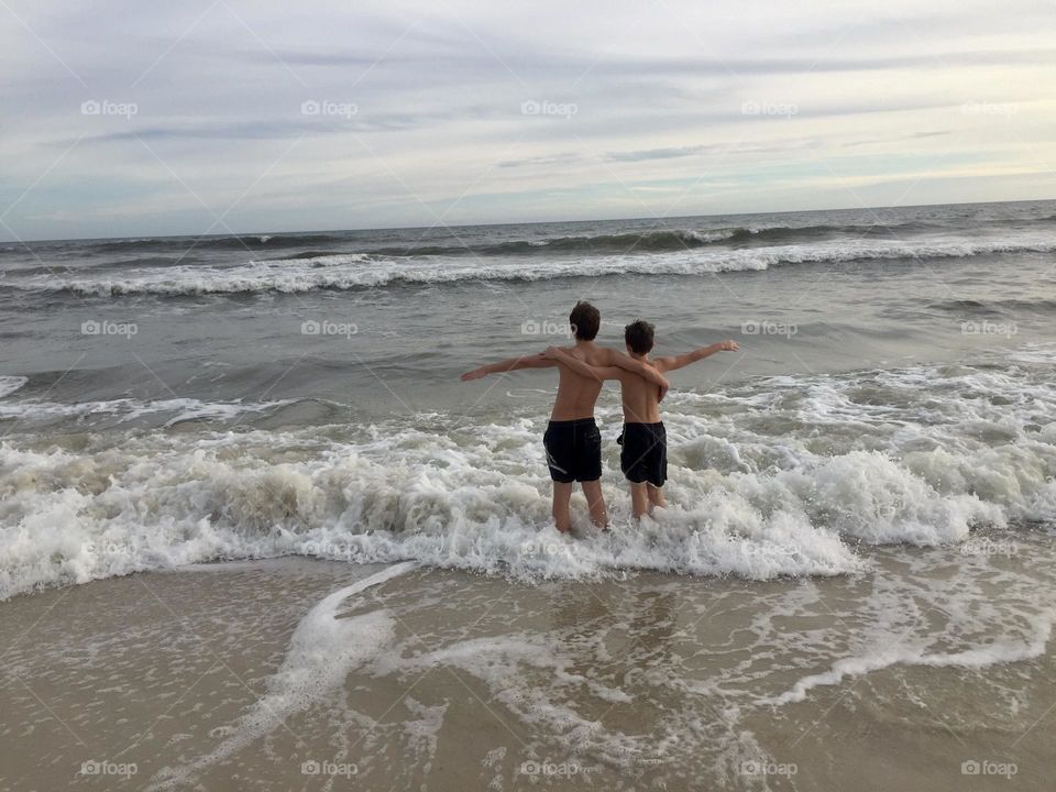 Brothers on vacation at the beach Gulf Shores Alabama USA ocean waves friendship brothers for life