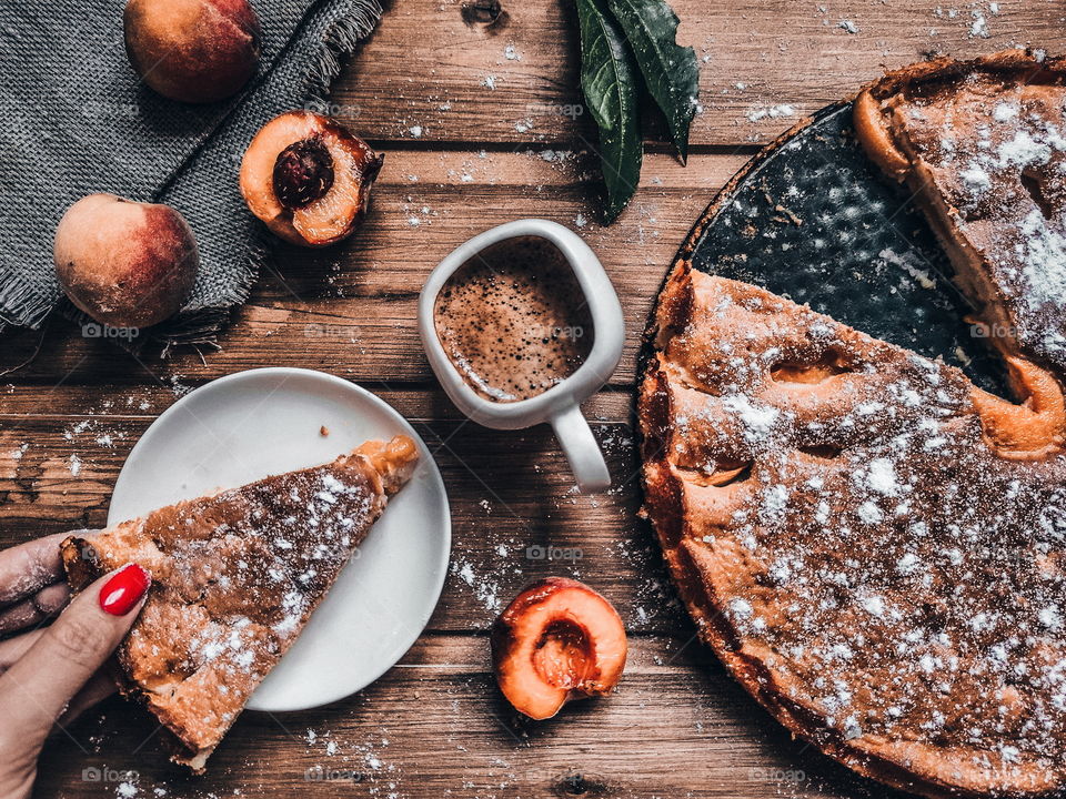 tasty peach pie and cup coffee on table