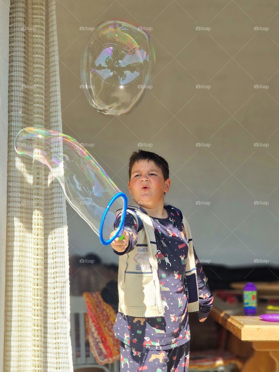 child making huge soap bubbles