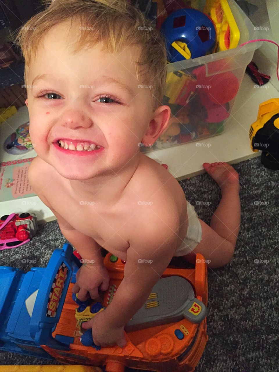 Small boy playing with toy in house