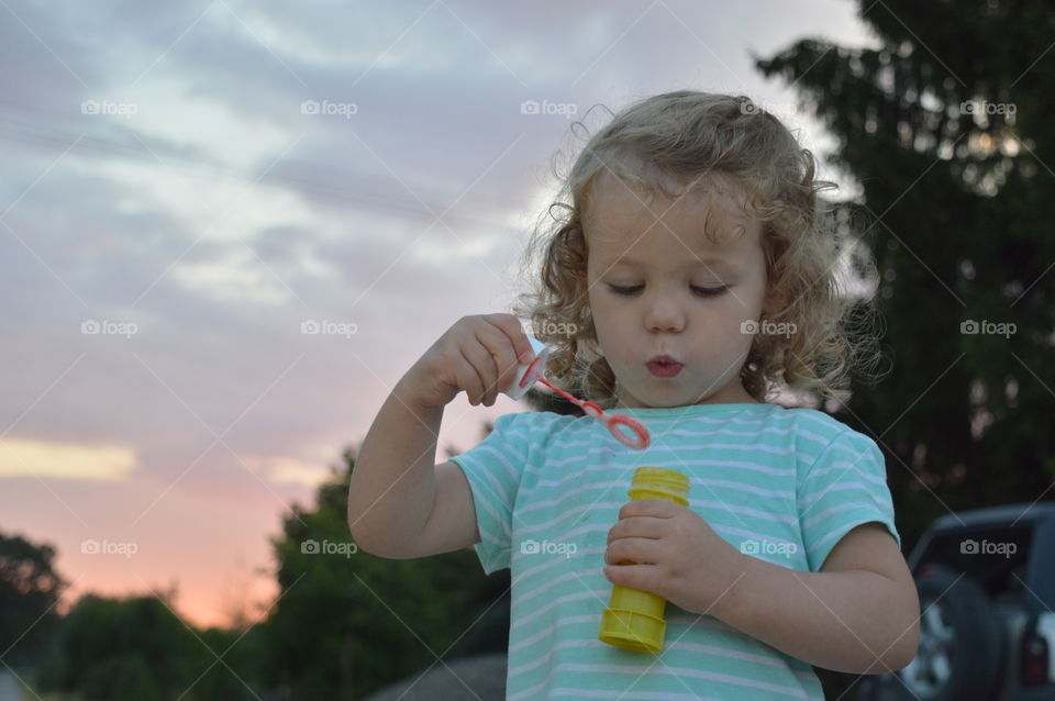 Girl trying to makes bubbles