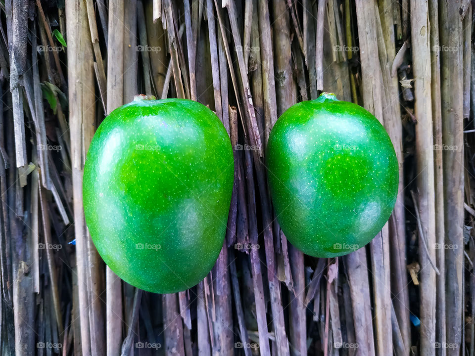 mango isolated on a rotted wood background