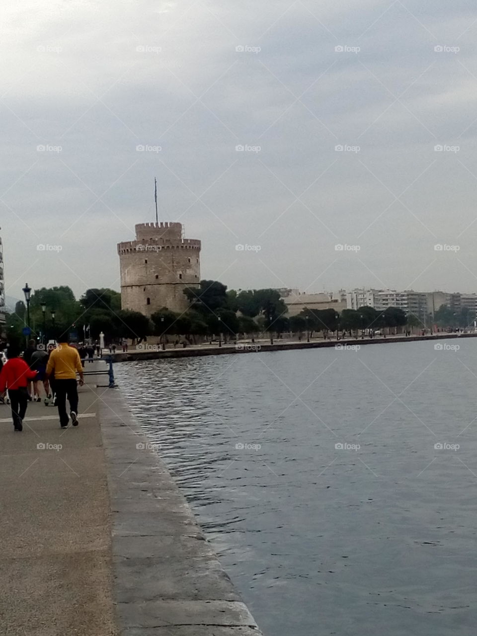 A lovely walk alongside the port of Thessaloniki. Approaching the White Tower in a cloudy autumn morning.