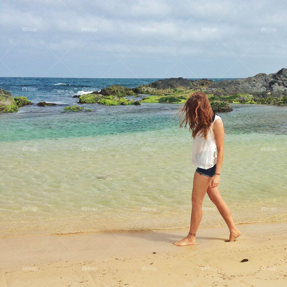 Girl walking on beach. 