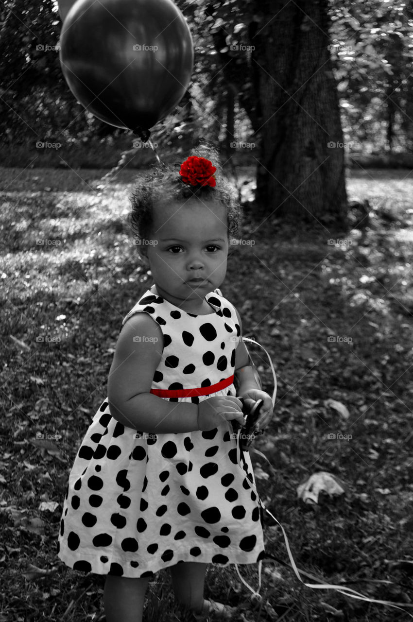 Cute african baby holding balloon