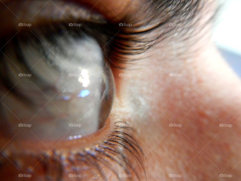 close-up of human eye with details of light brown iris