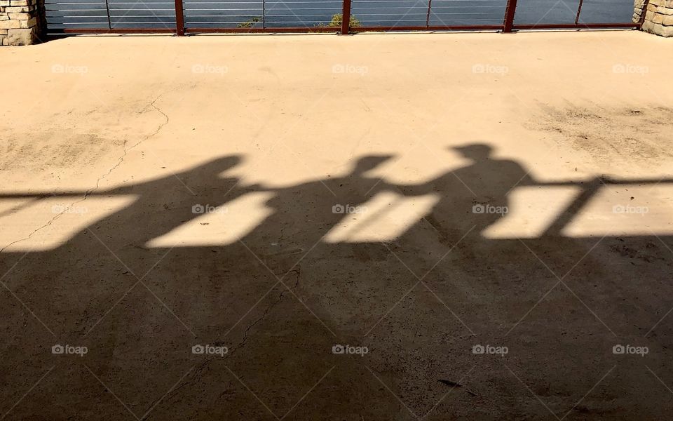 Shadows of three tourists on the balcony above at Guntersville