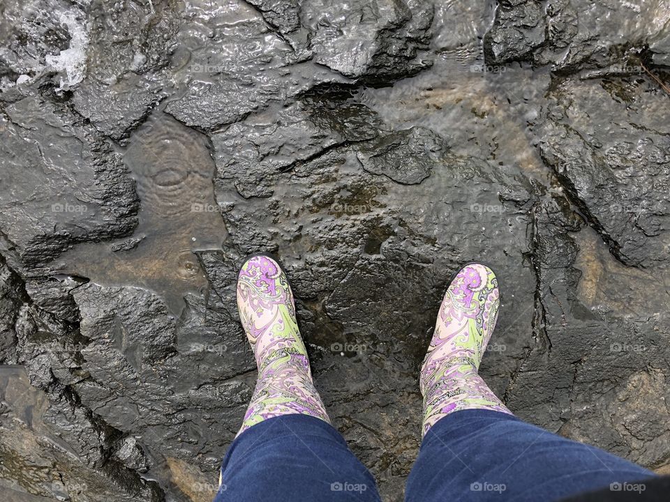 Rainboots atop a chuck of bedrock at a cabin in Ontario, Canada. 