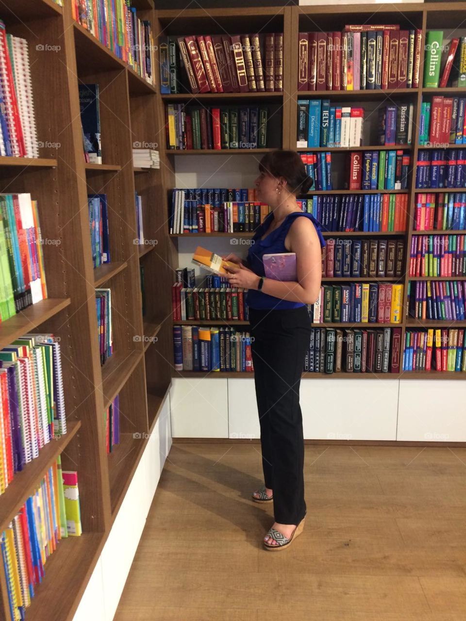 A girl chooses books in a bookstore