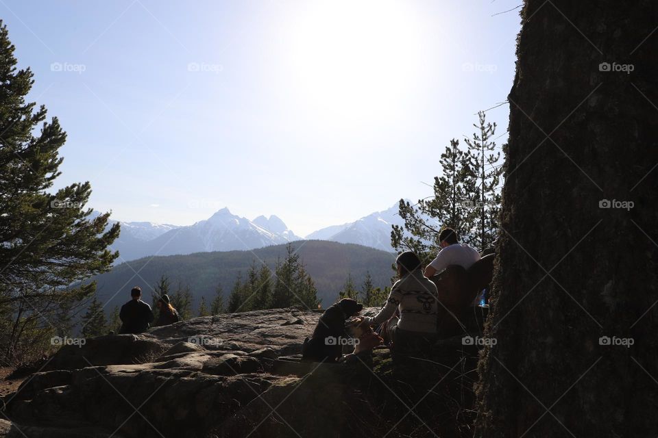 People pick nicking on a big rock