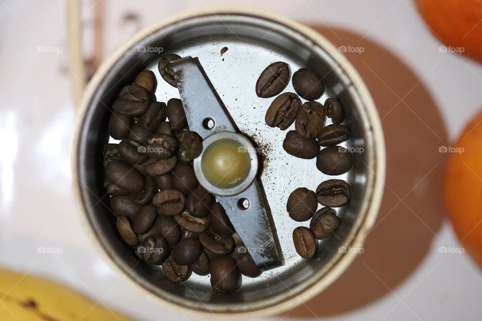 coffee beans in a coffee grinder