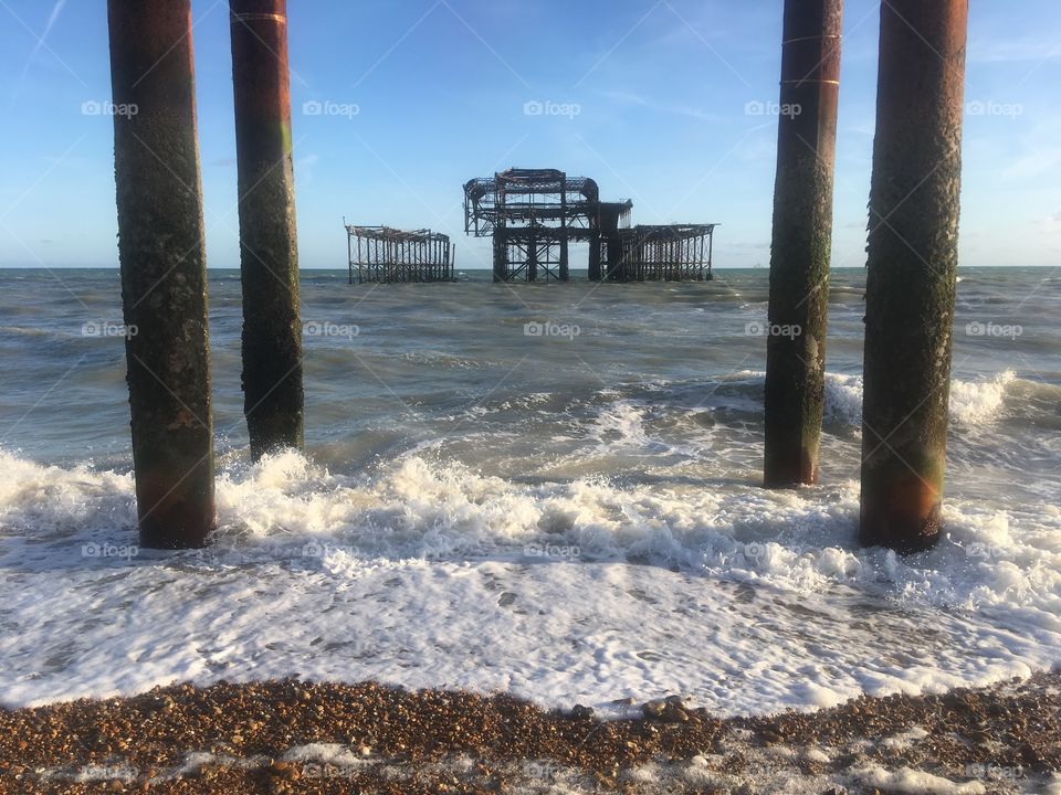 The remains of the West Pier in Brighton, England, damaged beyond repair by a Winter storm in 2002 and two separate arson attacks in 2003. Shot from the shingle shore in Summer.