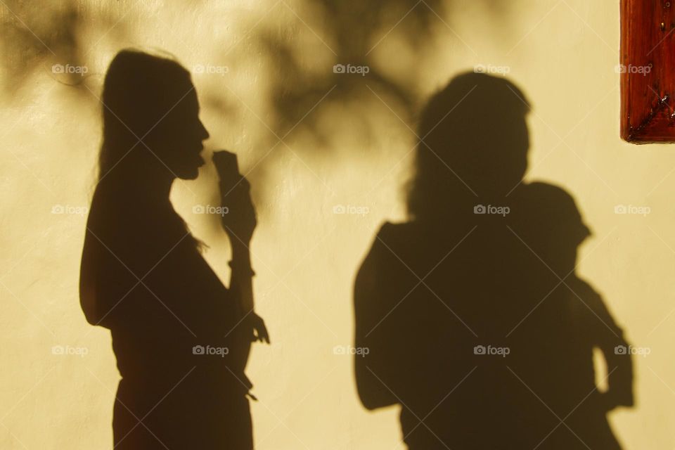 Shadow of a woman eating ice cream