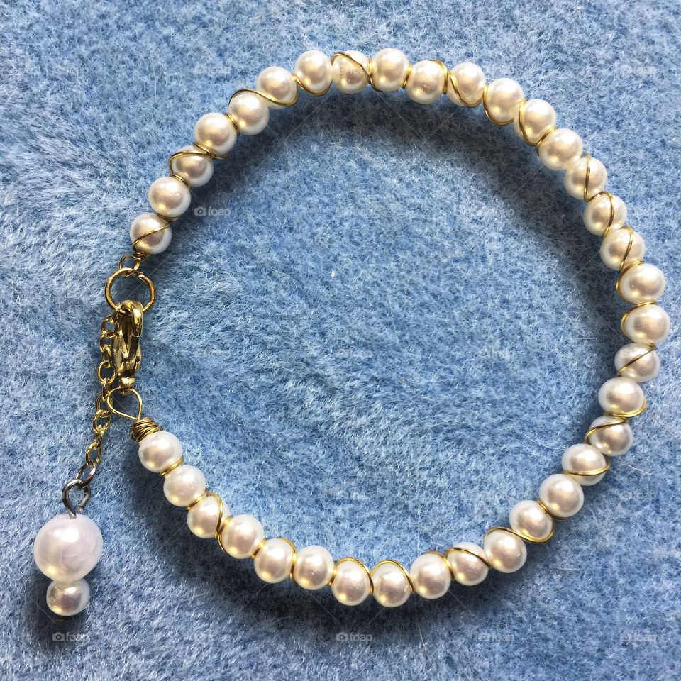Pearl bracelet on blue cloth