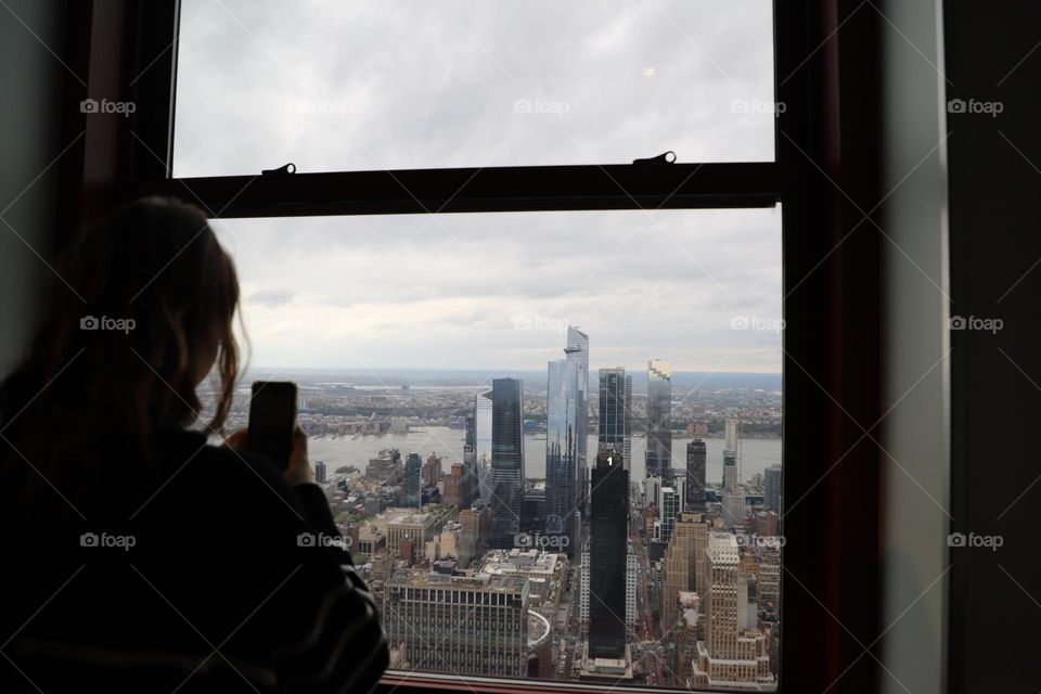 Young woman capturing the window view