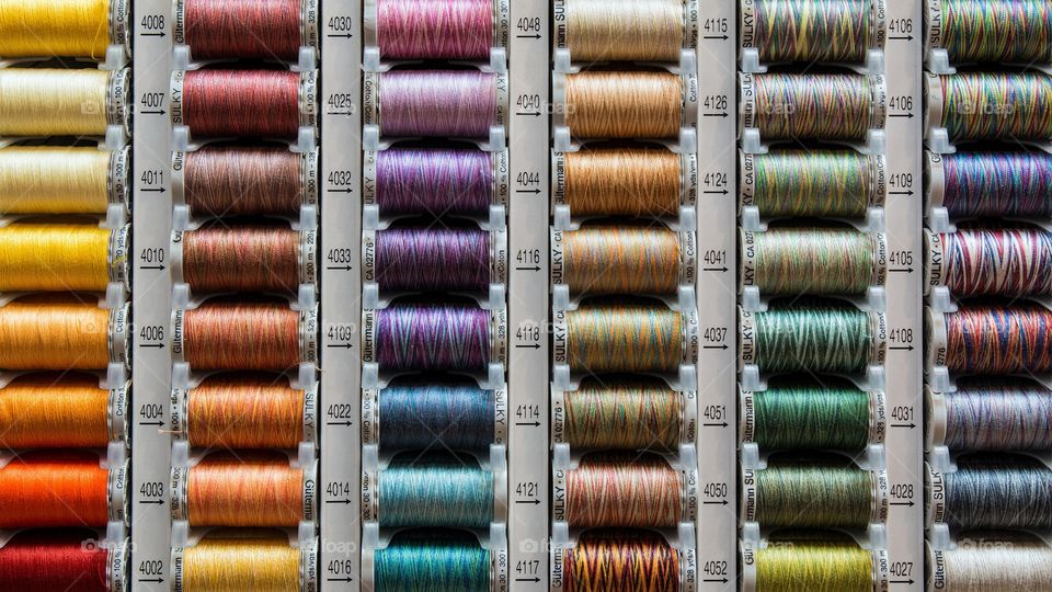 Full frame of multi colored spools