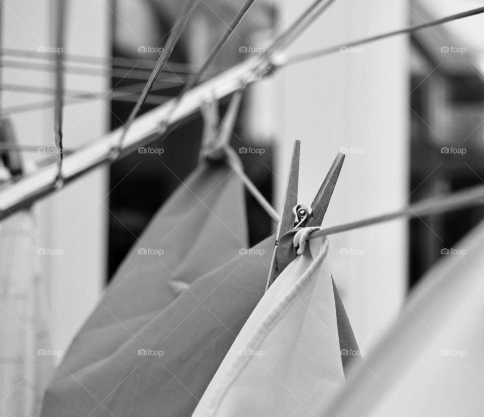 Black and white study of washing pegged on a rotary washing line. 