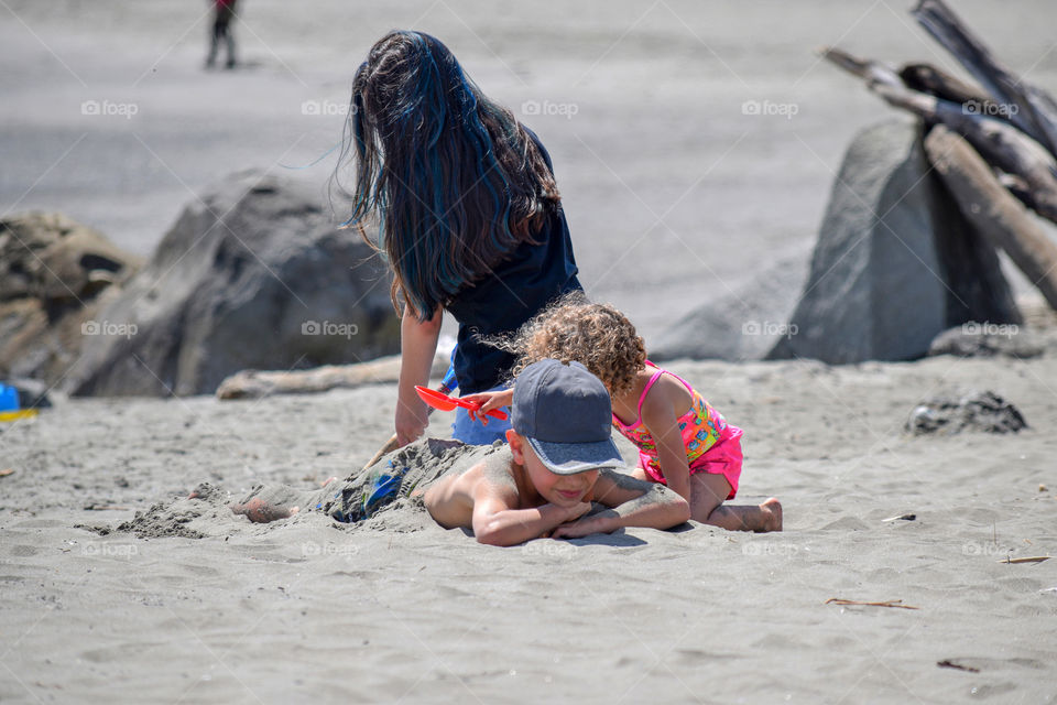 A family enjoying the beach in the summer