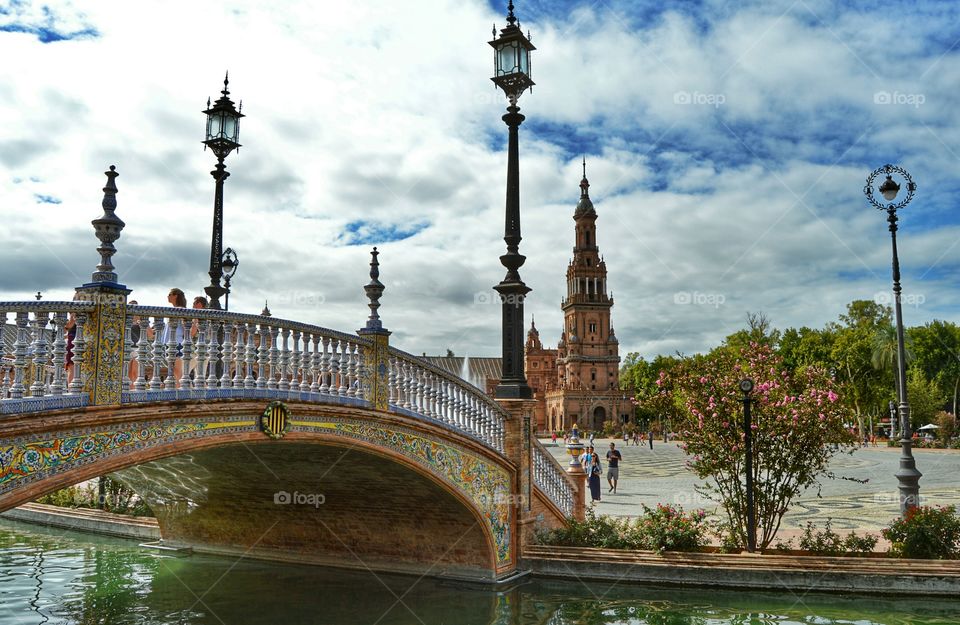 South Tower and tiled bridge. View of the south tower and one of the bridges at Plaza de España, Seville, Spain.